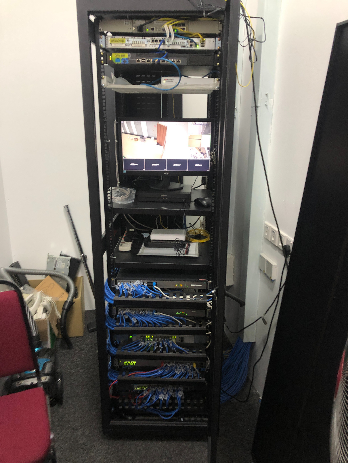 a rack full of network equipment and IP CAMERA NVR