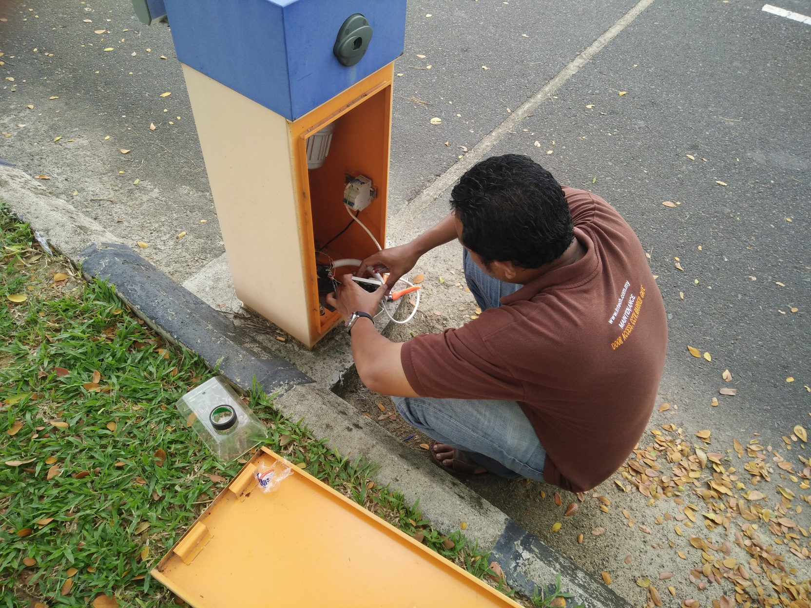 a person working on a barrier gate mag